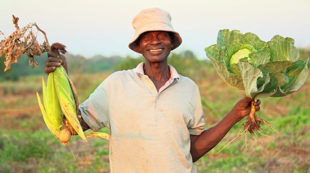 Local farmers holding fresh produce